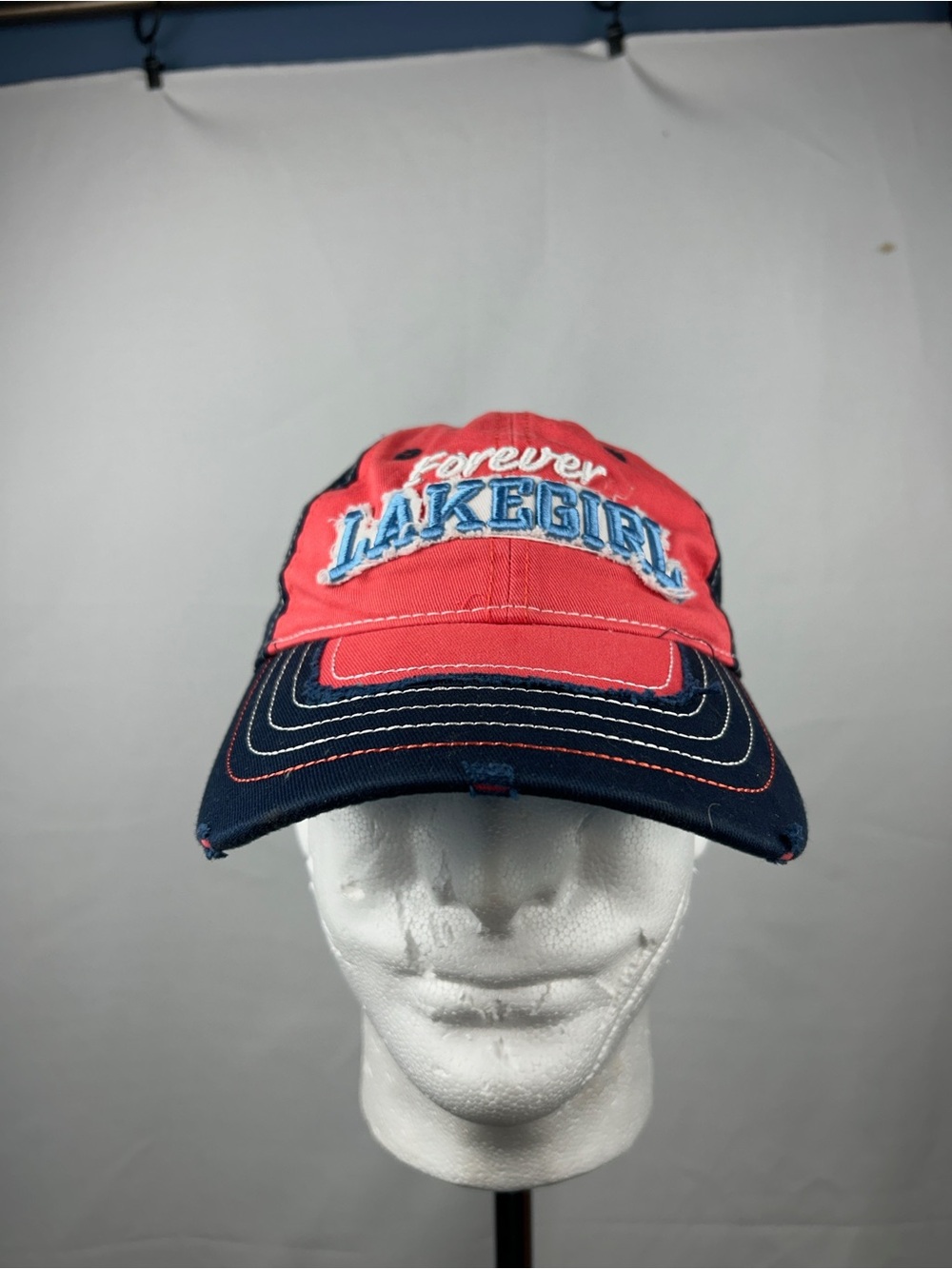 Forever Lakegirl women’s cap in red with a navy brim.